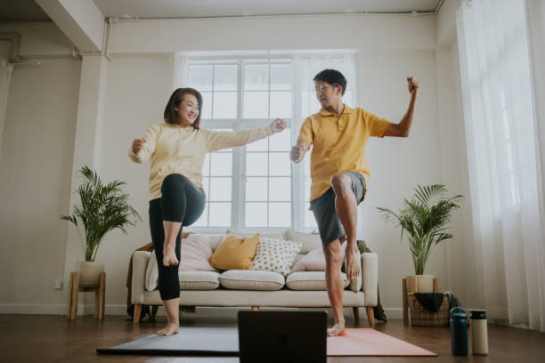 Home workout with love emotion-stock photo Happiness moment of mature couple enjoy exercising and aerobic dancing at home with positive emotion, home workout stock pictures, royalty-free photos & images