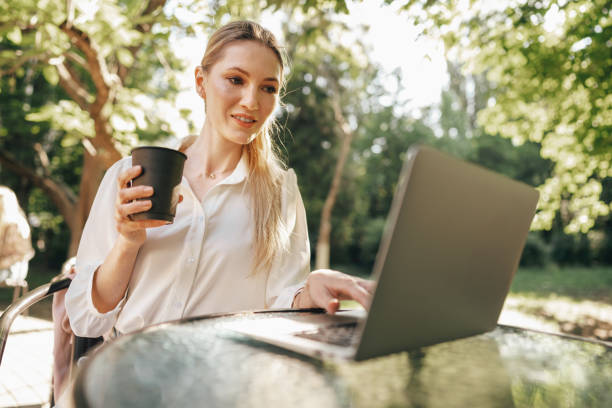 istock Young successful businesswoman using laptop for work outdoors 1329890864
