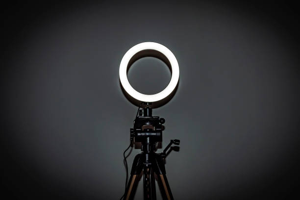 istock LED ring lamp with adjustable brightness for a studio camera, photo phone, video lamp with tripods 1329890878