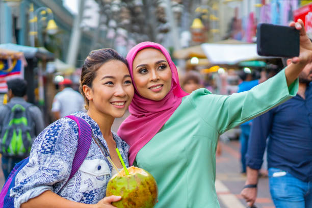 istock Young Beautiful Millennial Asian friends taking a selfie together while on a holiday. 1329892221