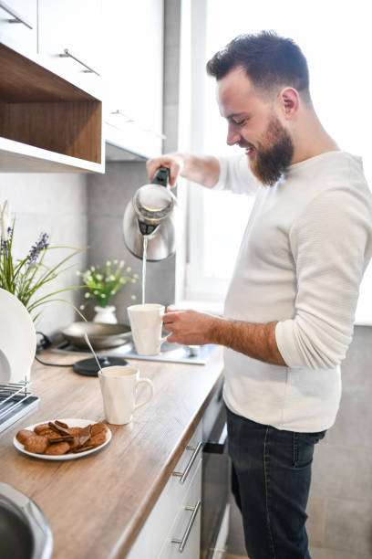 istock Coffee And Snack Time By Bearded Male In Kitchen 1329894428