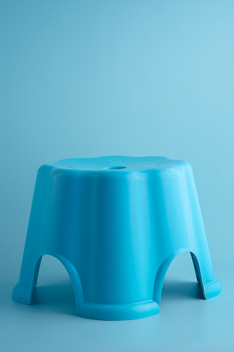 Small plastic chairs for children in blue on a blue background