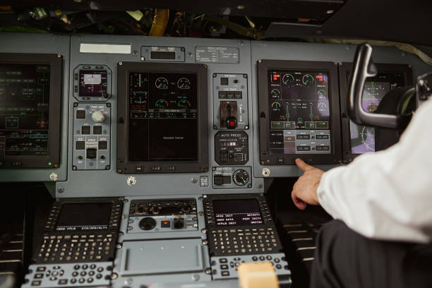 istock Male pilot pushing button on passenger airplane 1329895314