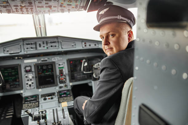 istock Male pilot in cockpit of passenger airplane jet 1329897270