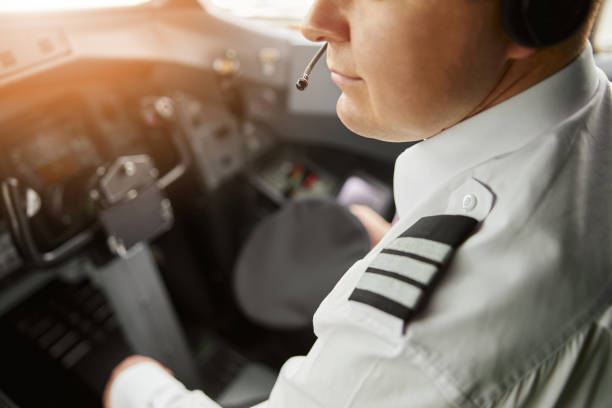istock Male pilot in cockpit of passenger airplane jet 1329897295