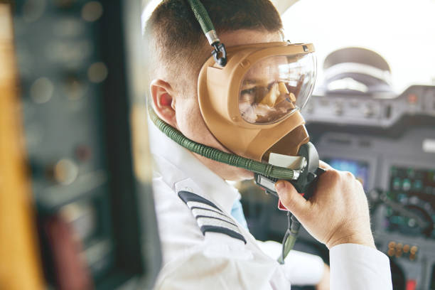 male pilot take off air mask in cockpit of plane - airplane cockpit taking off pilot imagens e fotografias de stock