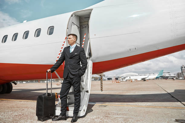 istock Flight attendant stand on runway near airplane jet 1329897507