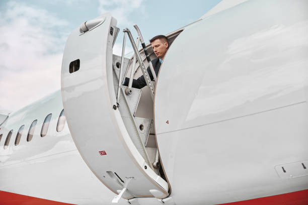 istock Flight attendant closed door of private airplane 1329897519