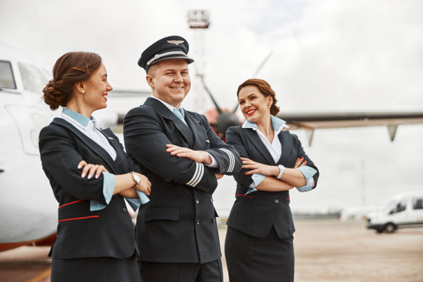 istock Pilot and stewardesses on runway near airplane jet 1329897962