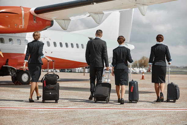 istock Plane team walking on runway to airplane 1329897968