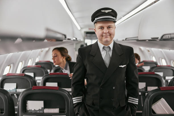 istock Pilot and stewardesses in passenger cabin of plane 1329897978