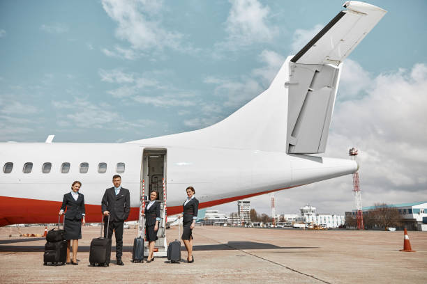 istock Plane team standing on runway near airplane 1329897979