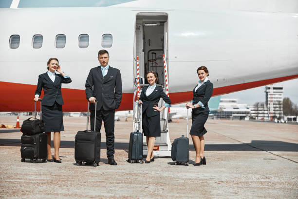 istock Plane team standing on runway near airplane 1329898511