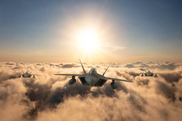 istock Jet fighters flying over the clouds at sunset. 1329898539