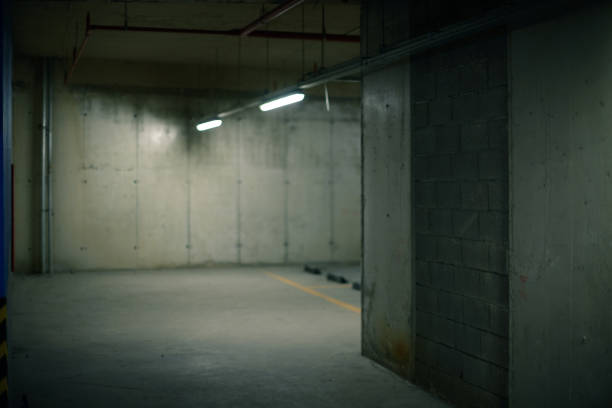 istock Two fluorescent lights concrete walls and floor background. 1329901671