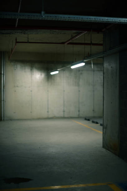 istock Two fluorescent lights concrete walls and floor background. 1329901695