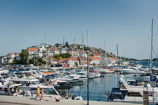 Summer vibes in the little idyllic town Kragerø, Norway. Boats are moored on the piers, and people enjoy themselves at sea. Krageø is the southernmost town on Telemark county.