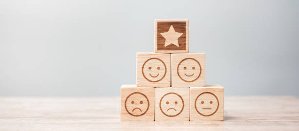 istock emotion face and Star symbol blocks on table background. Service rating, ranking, customer review, satisfaction, evaluation and feedback concept 1329902940