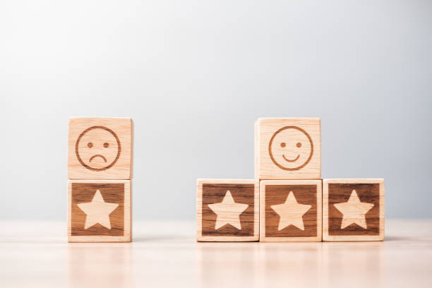 istock emotion face and Star symbol blocks on table background. Service rating, ranking, customer review, satisfaction, evaluation and feedback concept 1329902974