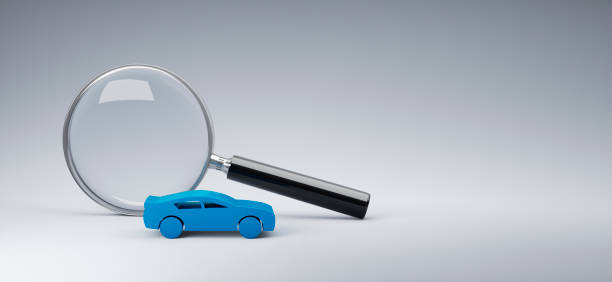istock Magnifying glass with blue toy car 1329905546