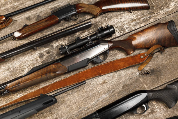 istock Many hunting rifles on weathered wooden surface 1329905623
