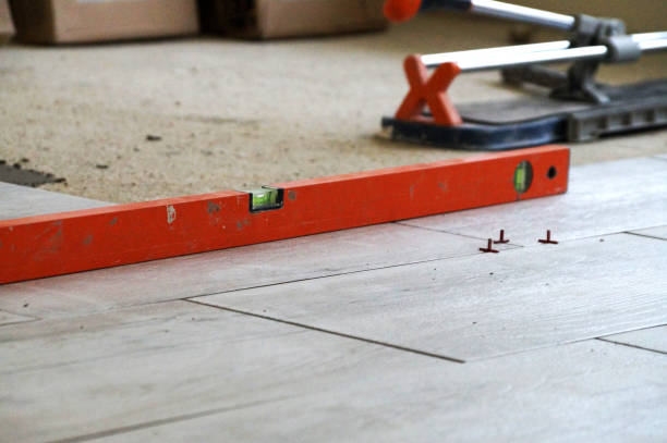 istock measuring level and manual tile cutter on porcelain stoneware floor 1329906388