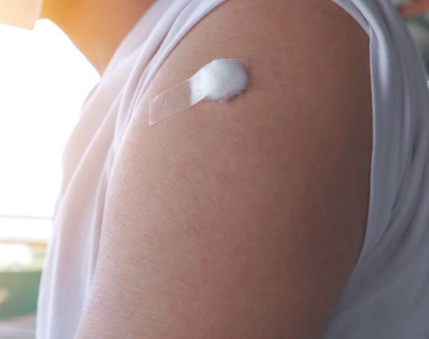 istock Man with bandage from vaccine 1329911460