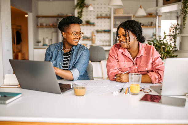 istock Two female students studying together at home 1329912147