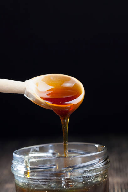 istock current thick and delicious sweet honey, close up 1329912323