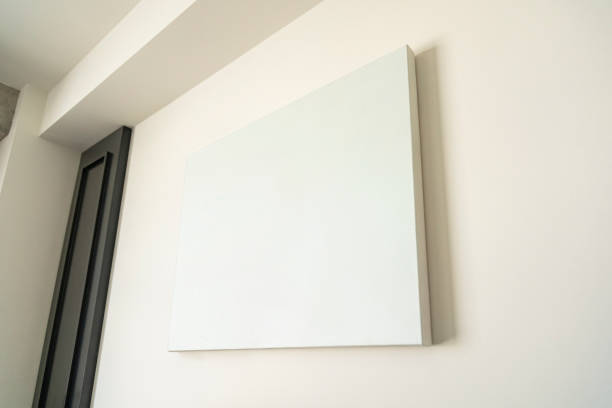 istock Empty canvas, poster, blank frame canvas, mock up, on a white wall, living room, home template, low angle view 1329916316