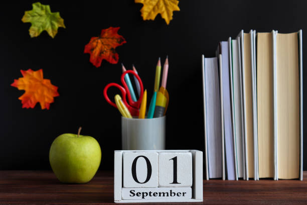 istock Back to school concept. School stationery and calendar dated September 1st. Selective focus 1329916354