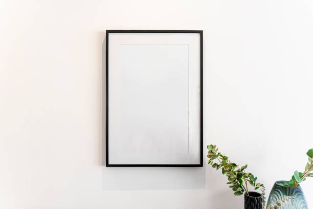 istock Home decoration, empty black frame, poster, white canvas, mock up on a white wall, living room, front view 1329916451