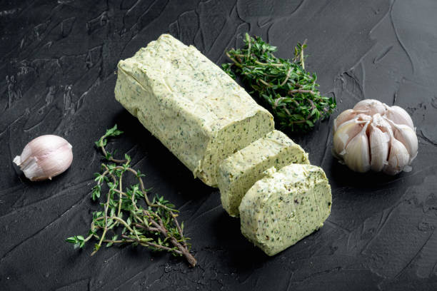 istock Fresh green herb butter, on black stone background 1329916477
