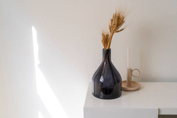 istock Home accent decor, dark glass bottle, modern decoration, candle holder, over white console table 1329916540