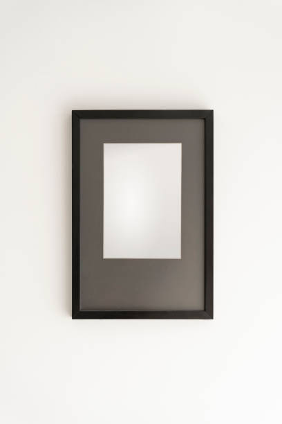 istock Interior decoration, black frame, poster white canvas mock up on a white wall, living room, template front view 1329917303