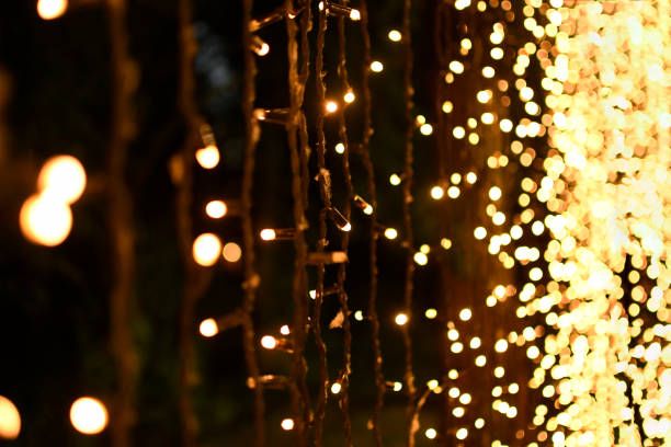 istock Festive garlands with yellow lights in perspective. 1329918373
