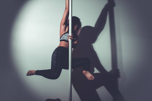 istock young asian woman doing pole dance at home 1329919727