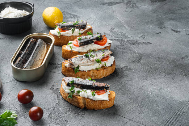istock Crostini with fish and ricotta, on gray stone table background, with copy space for text 1329921652