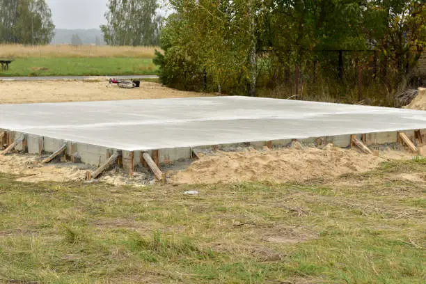 Photo of Concrete poured slab foundation in formwork.