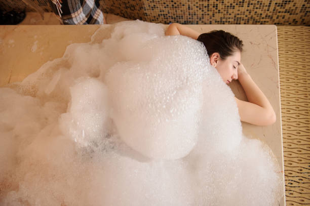 istock woman in white foam relaxing in a hammam 1329922918