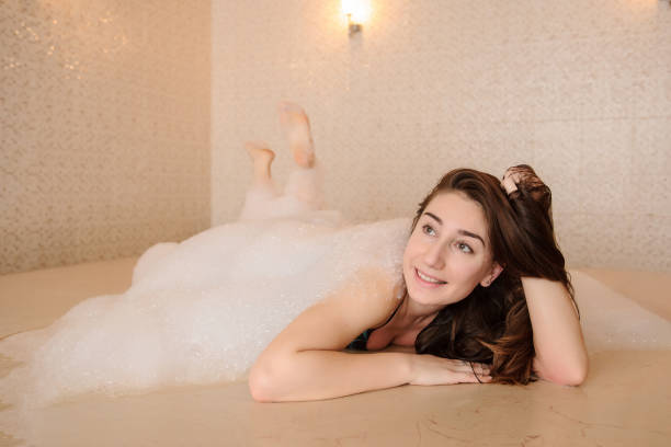 istock woman in white foam relaxing in a hammam 1329922961
