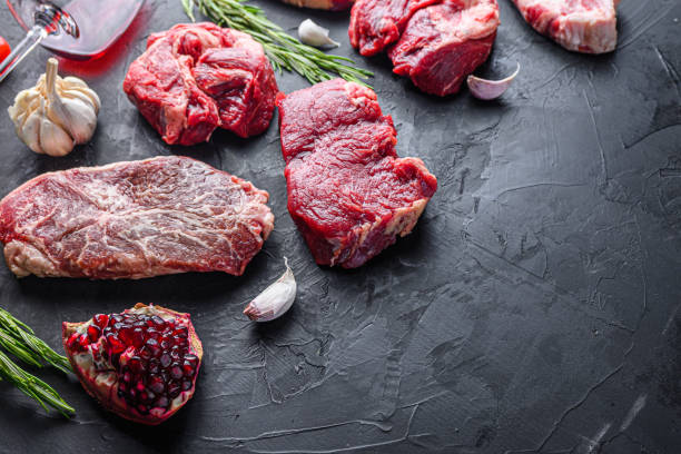 istock Alternative beef steak cuts with top blade, chuck roll and rump steak, side view with space for text. 1329923176
