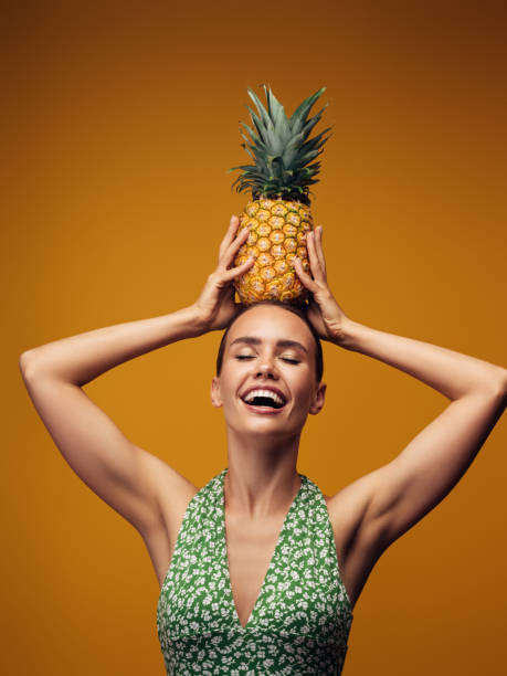 istock Beautiful girl with pineapple 1329923203