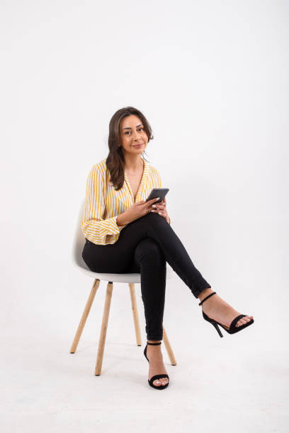 istock portrait of young woman using electronic device. 1329923252