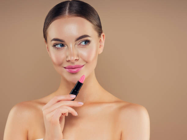 istock Beautiful girl applying make-up 1329923994