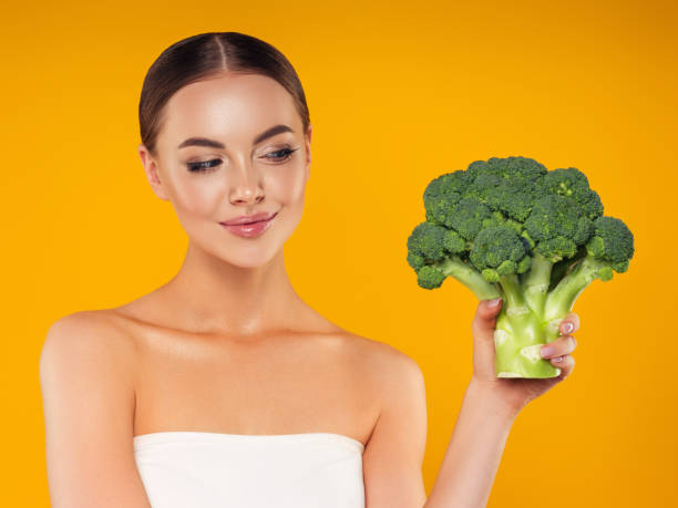 Beautiful girl with broccoli