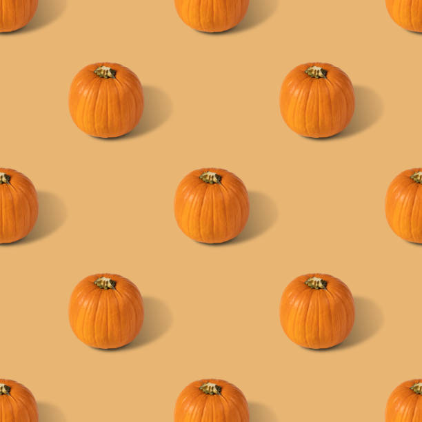 istock Pumpkin seamless pattern on a beige background. Vegetable pattern for the print. Autumn abstract background. 1329925213