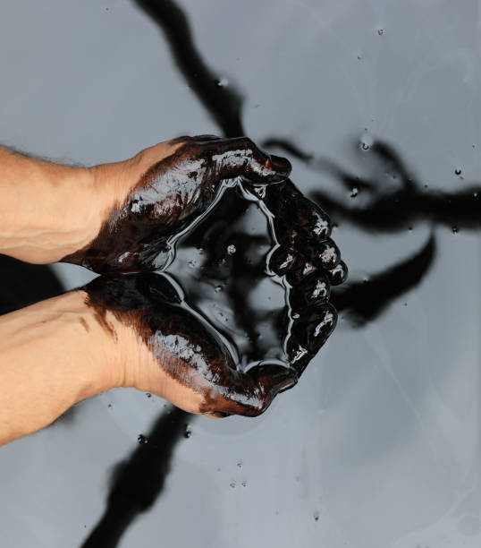 istock hands in crude black petroleum 1329925233