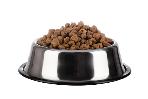 Cats and dogs dry food in a stainless steel bowl on a white background. Pet kibble food in bowl.