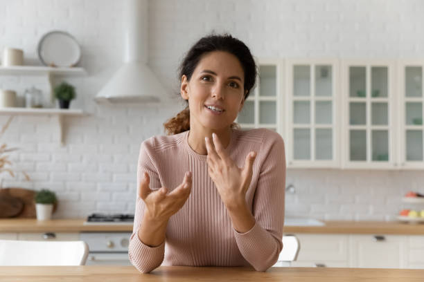 istock Professional female blogger talking recording video in modern kitchen. 1329929655